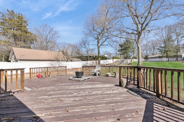 wooden terrace featuring a yard and a fenced backyard