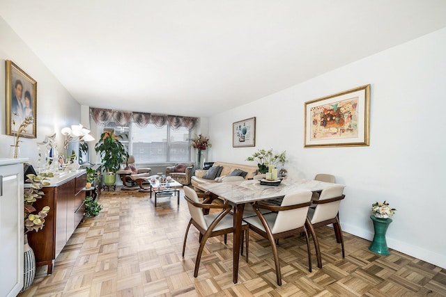 dining area featuring light parquet floors