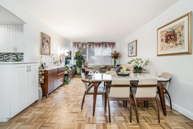 dining area featuring light parquet floors