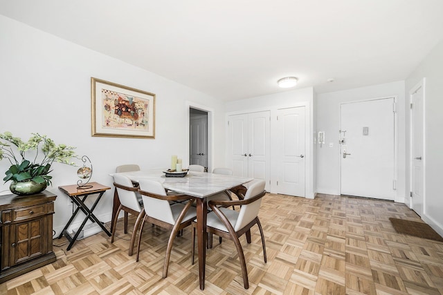 dining space with light parquet flooring