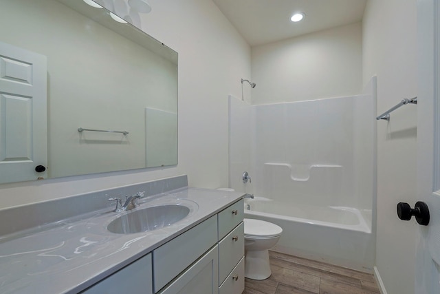 full bathroom featuring vanity, hardwood / wood-style floors,  shower combination, and toilet