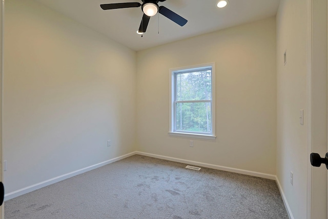 carpeted spare room featuring ceiling fan