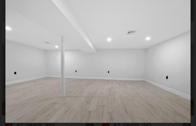 basement with light hardwood / wood-style flooring