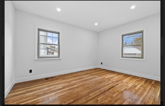 unfurnished room featuring light hardwood / wood-style floors