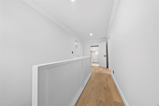 hallway featuring ornamental molding and light hardwood / wood-style flooring