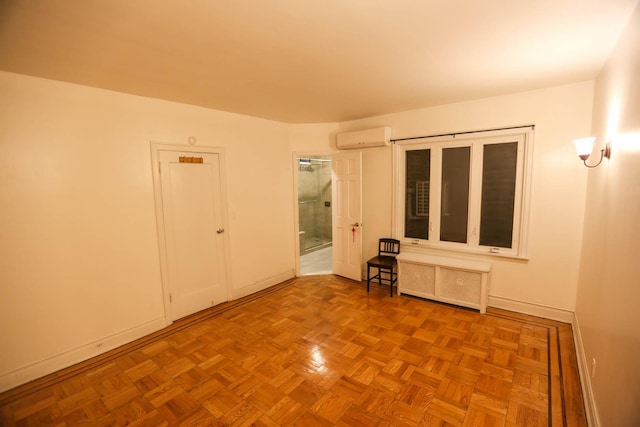 empty room featuring light parquet flooring, radiator, and a wall mounted AC