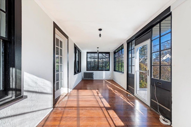 unfurnished sunroom featuring radiator