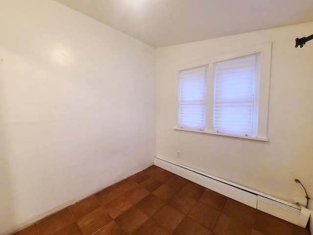 unfurnished room with baseboard heating