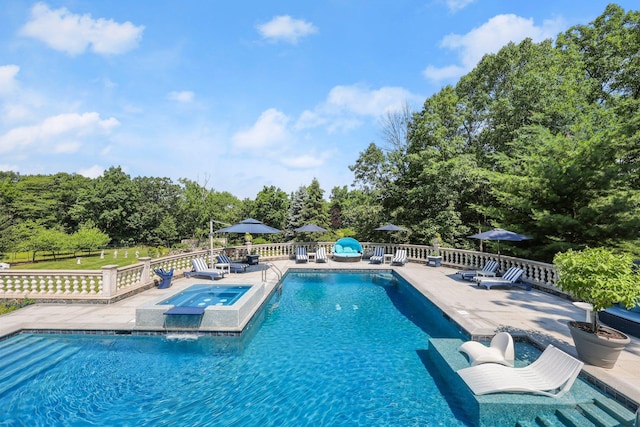 view of swimming pool featuring a patio area and an in ground hot tub