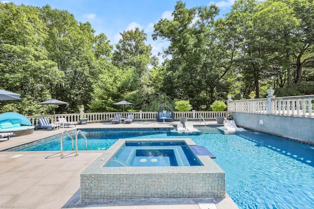 view of pool with an in ground hot tub and a patio