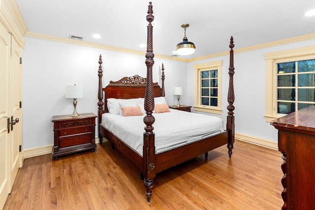 bedroom featuring light hardwood / wood-style floors and ornamental molding