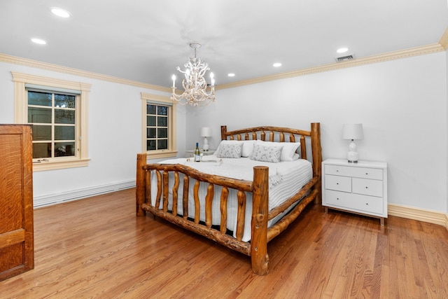 bedroom featuring light hardwood / wood-style floors, crown molding, and a notable chandelier