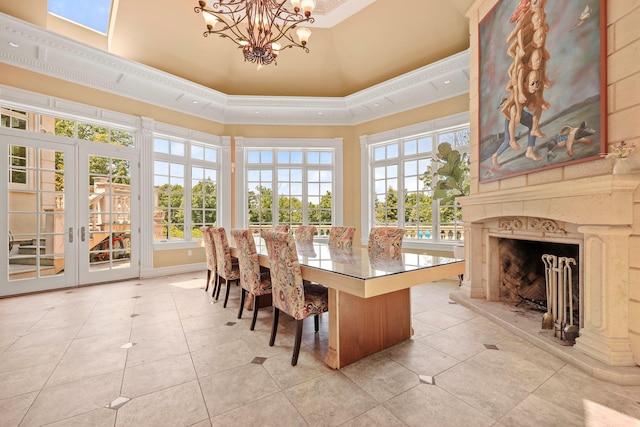 dining area featuring french doors, tile patterned floors, ornamental molding, a premium fireplace, and a high ceiling