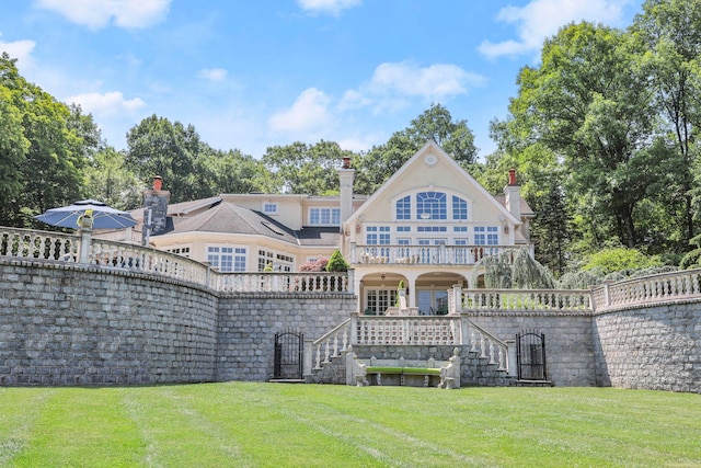 rear view of property with a yard