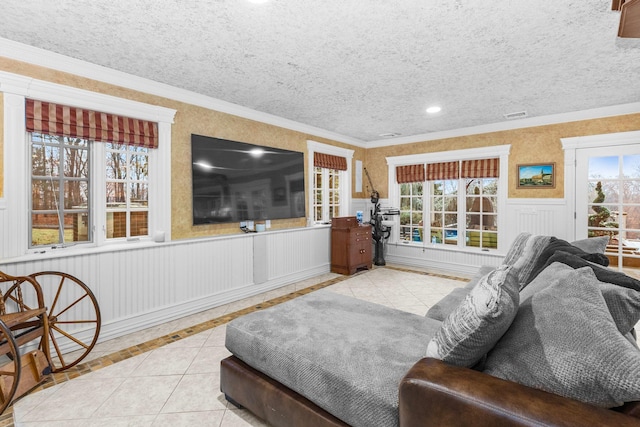 living room featuring a textured ceiling, light tile patterned floors, and ornamental molding