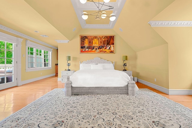 bedroom featuring a notable chandelier, access to exterior, wood-type flooring, and vaulted ceiling