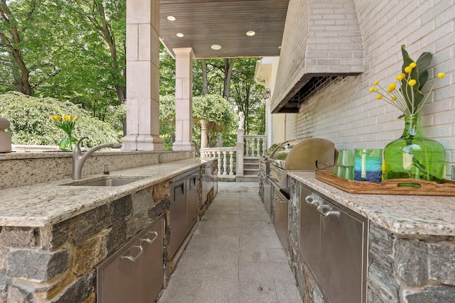 view of patio / terrace with area for grilling, sink, and an outdoor kitchen