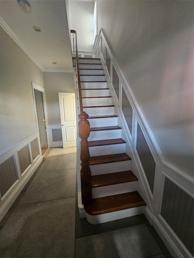 staircase featuring crown molding