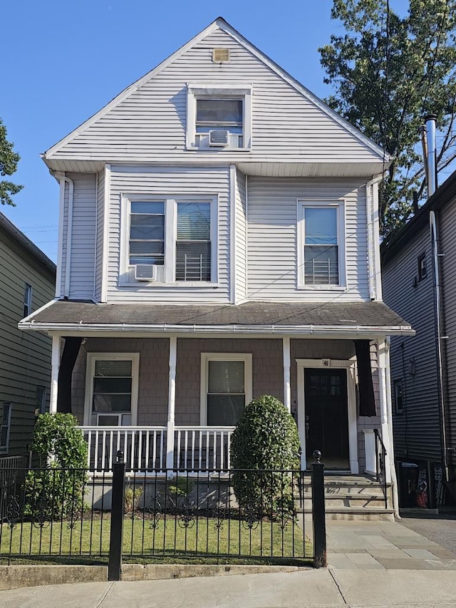 view of front of property featuring a porch and cooling unit