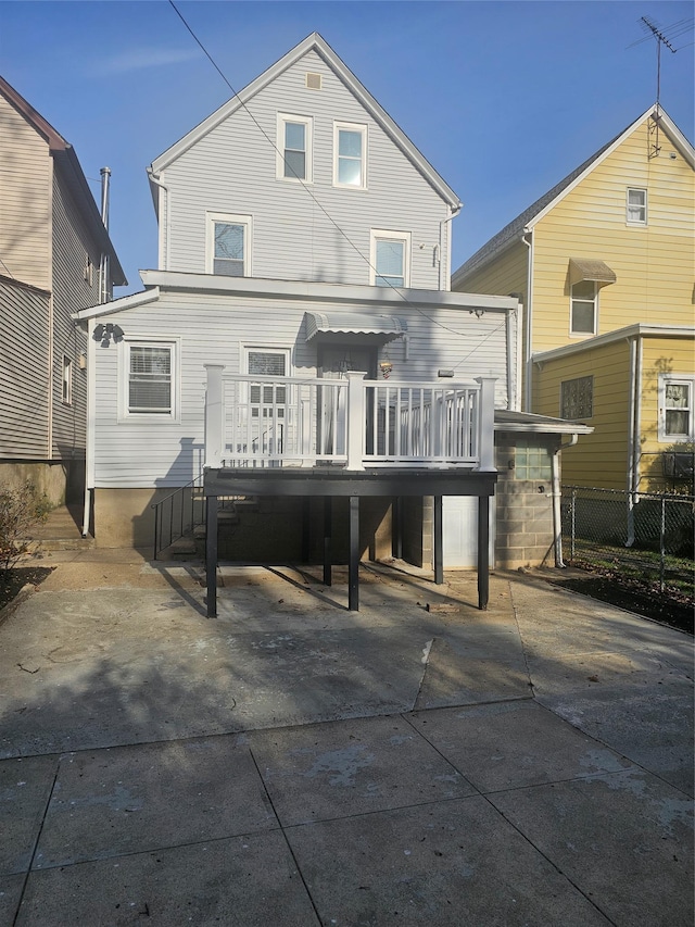 rear view of property featuring a deck