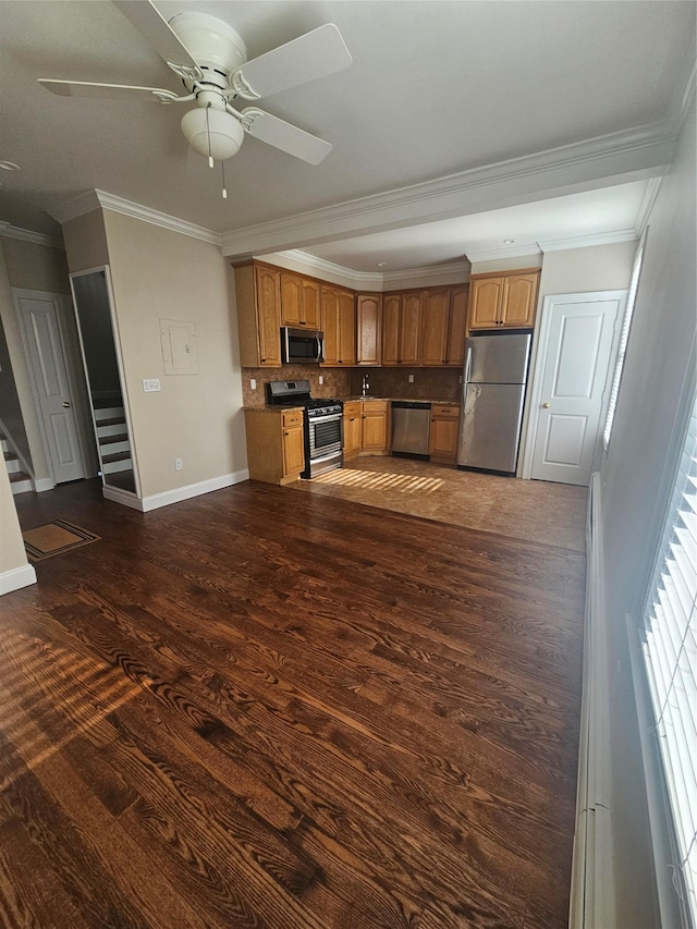 kitchen featuring ceiling fan, tasteful backsplash, dark hardwood / wood-style flooring, crown molding, and appliances with stainless steel finishes