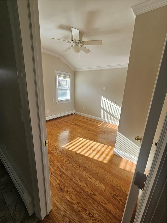 additional living space with hardwood / wood-style floors, vaulted ceiling, baseboard heating, and ceiling fan