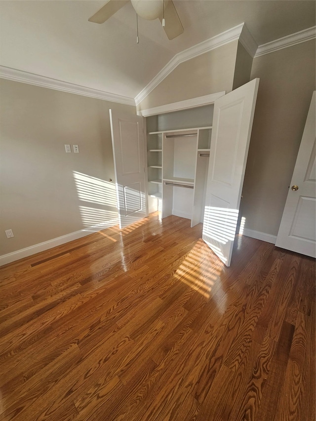 unfurnished bedroom with dark hardwood / wood-style flooring, a closet, ceiling fan, and crown molding