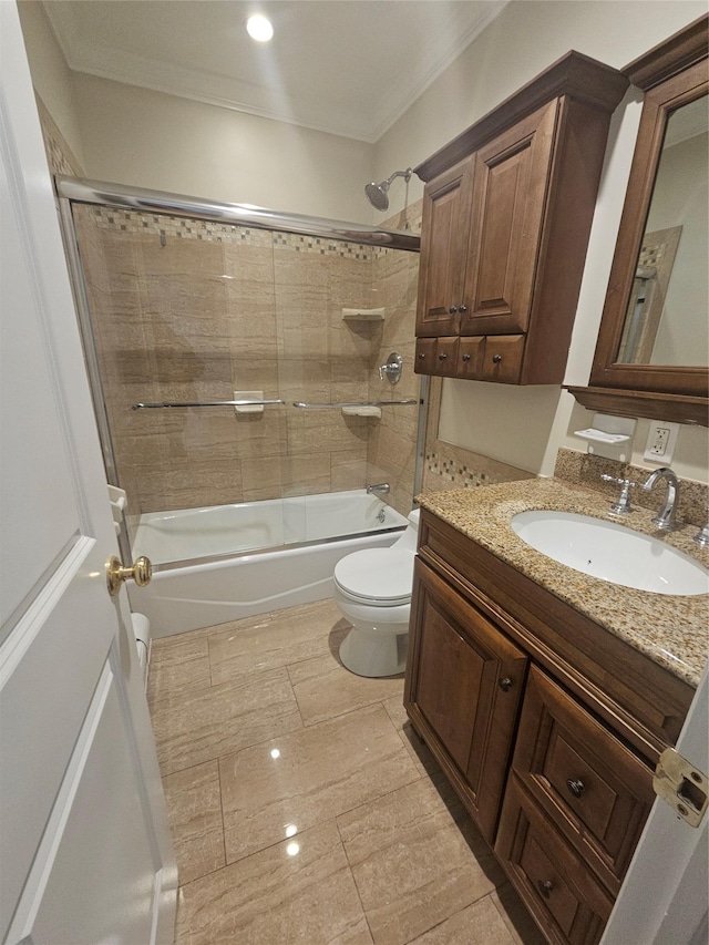 full bathroom featuring shower / bath combination with glass door, crown molding, vanity, and toilet