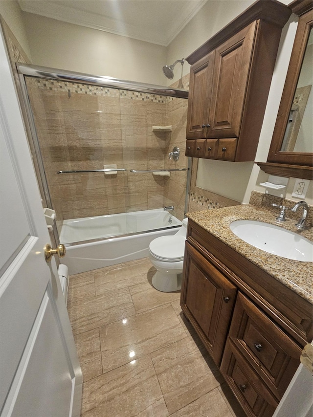 full bathroom with vanity, toilet, ornamental molding, and tiled shower / bath