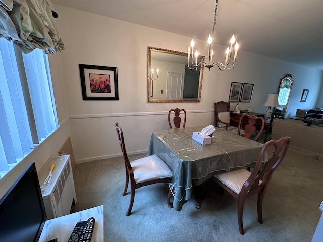 dining room featuring carpet and a notable chandelier