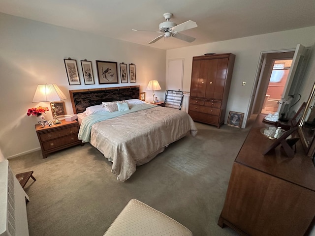 bedroom featuring carpet floors, ceiling fan, and connected bathroom