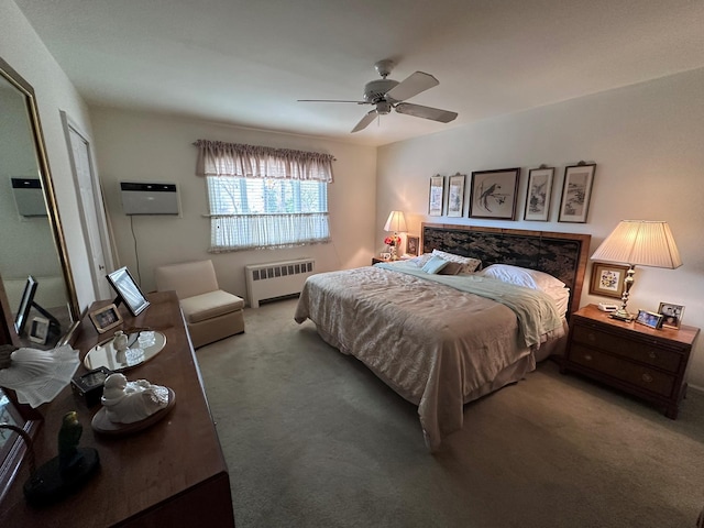 bedroom featuring carpet, a wall unit AC, radiator, and ceiling fan