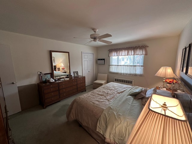 bedroom with ceiling fan, a closet, carpet floors, and radiator heating unit