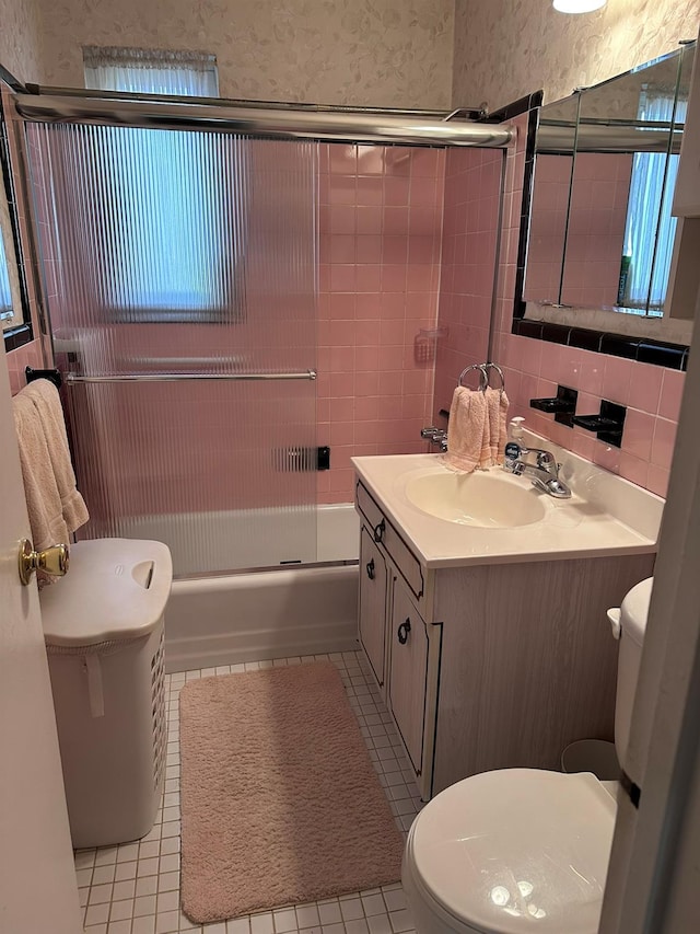 full bathroom with tile patterned floors, vanity, toilet, and tasteful backsplash