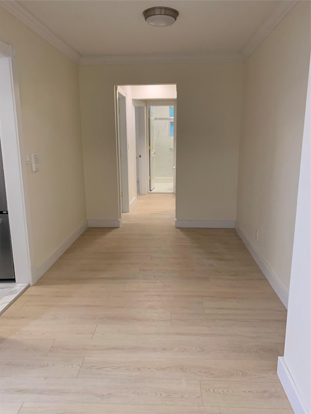 corridor featuring light hardwood / wood-style floors and crown molding