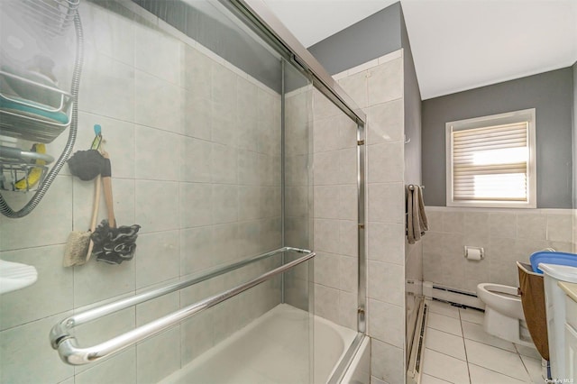 full bathroom featuring a baseboard heating unit, tile patterned floors, toilet, vanity, and tile walls