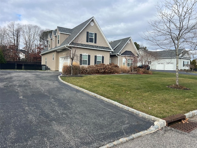 view of front of home with central air condition unit and a front lawn