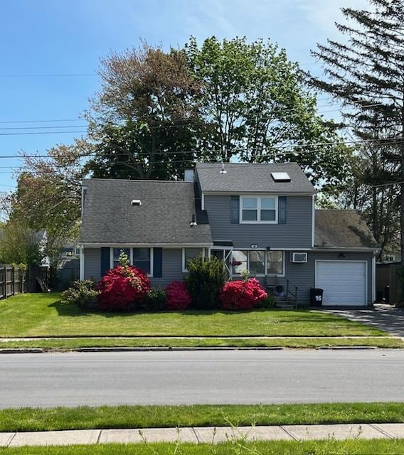 view of front facade featuring a front yard and a garage