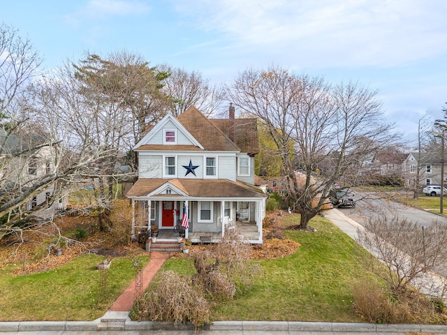 victorian home with covered porch and a front lawn