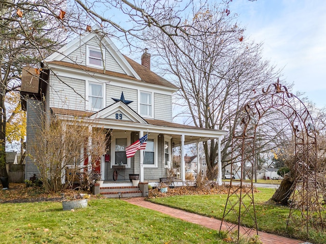 view of front facade with covered porch and a front lawn