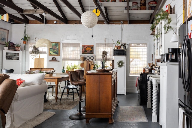 kitchen with refrigerator with ice dispenser, lofted ceiling with beams, and wood ceiling