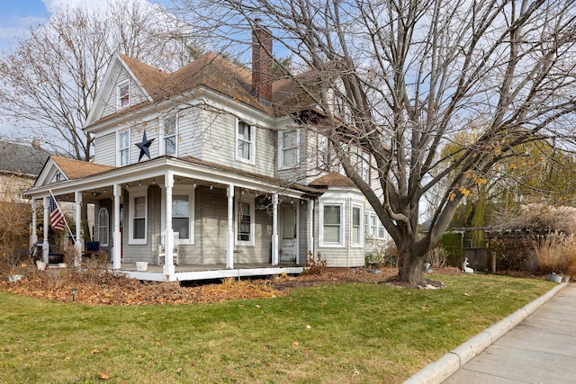 view of front of house featuring a porch and a front lawn