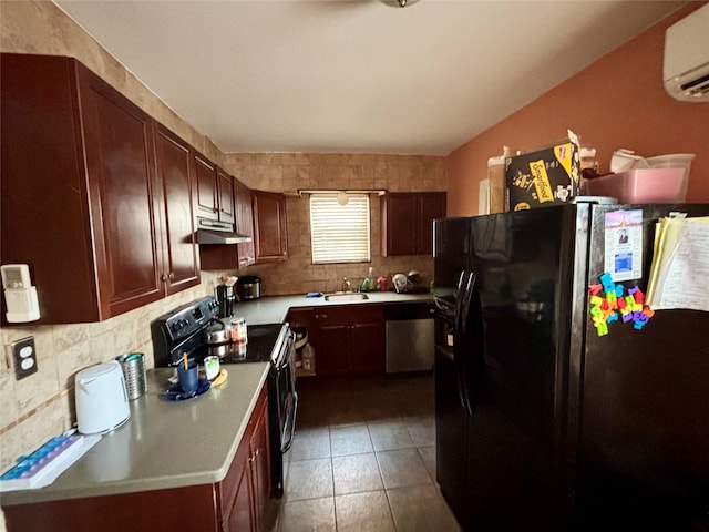 kitchen featuring tasteful backsplash, a wall unit AC, dark tile patterned floors, sink, and black appliances