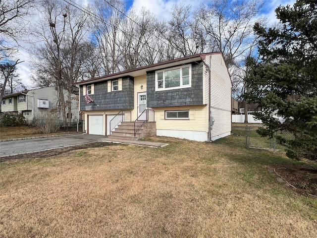 bi-level home with a front lawn and a garage