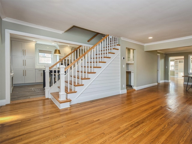 interior space featuring light wood-type flooring and crown molding