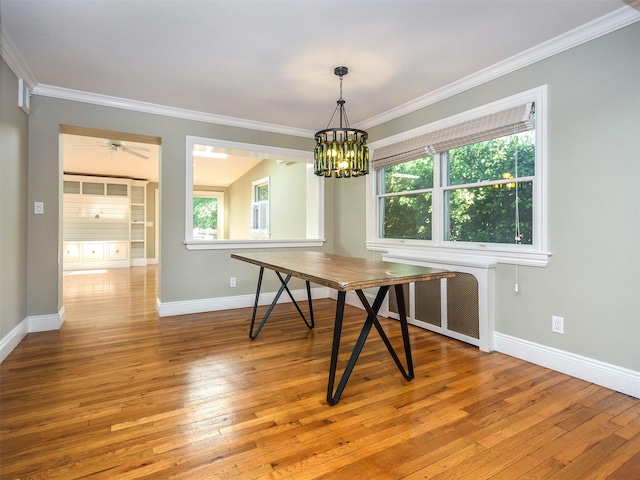 unfurnished dining area featuring hardwood / wood-style flooring, crown molding, and a wealth of natural light