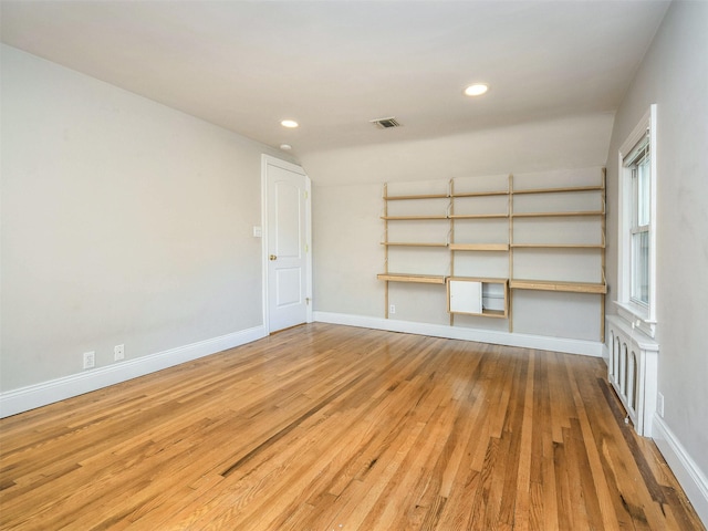 empty room with hardwood / wood-style flooring