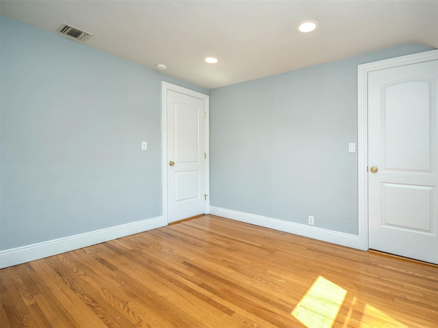 spare room featuring light wood-type flooring