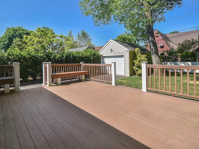 wooden terrace with a garage and an outbuilding