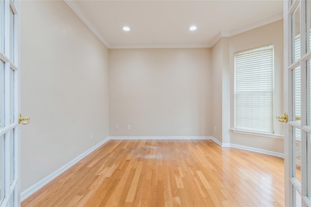 spare room featuring light hardwood / wood-style floors and crown molding